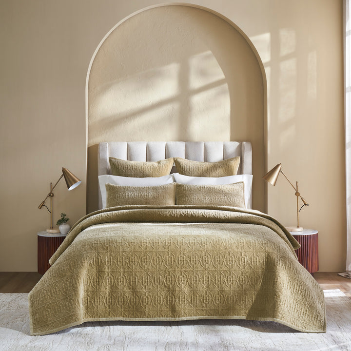 QT-377-9496_1|Elegant tan quilted bedspread with a geometric pattern, draped over a bed with white sheets and pillows, enhancing cozy bedroom decor.