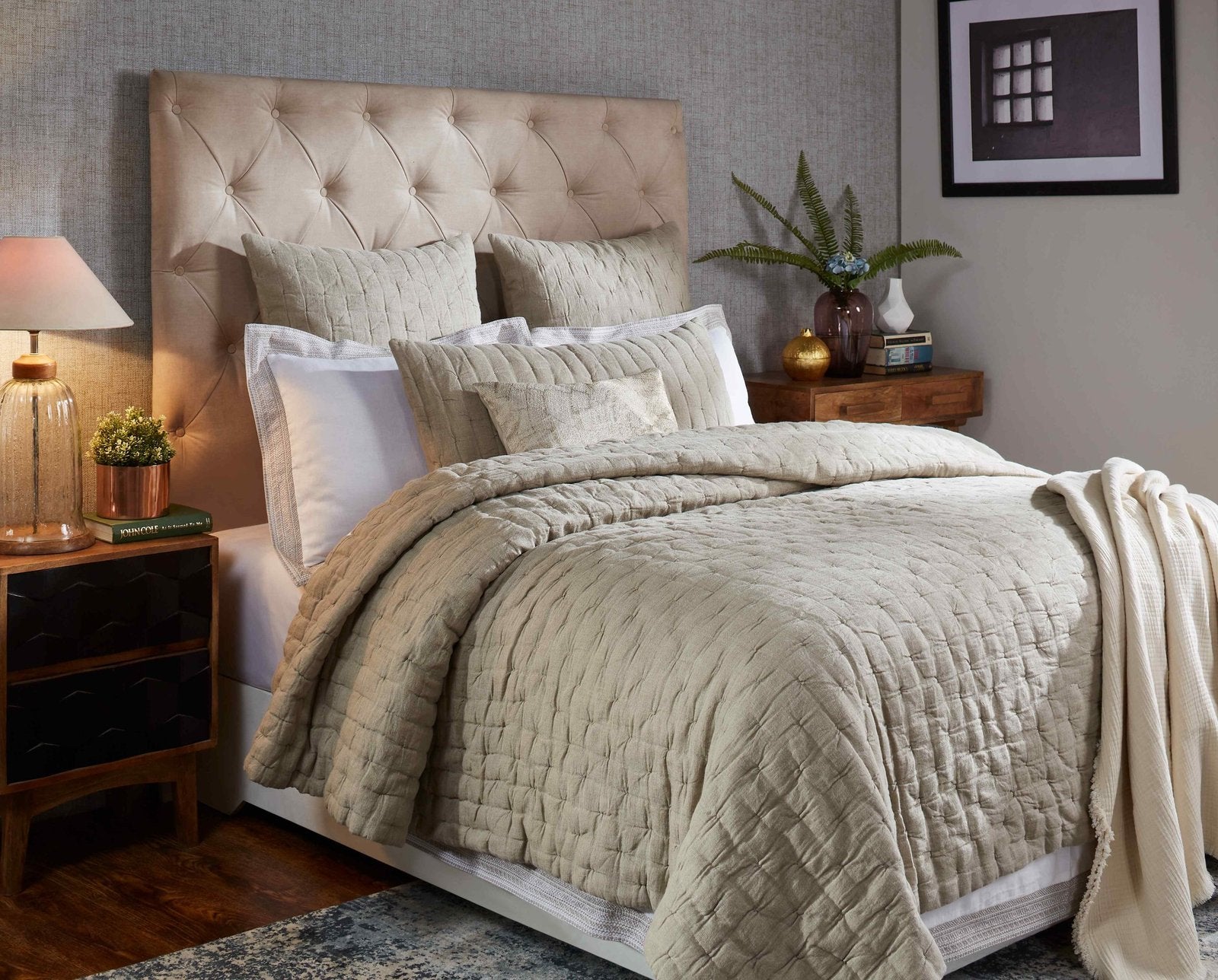 QT-320-9496_4|Beige quilted bedspread with a cream throw, enhancing a cozy bedroom with its soft texture and inviting layered look.