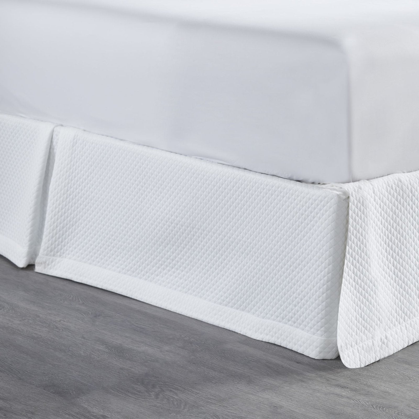 BS-117-7880_2|Close-up of white quilted panel bed skirt, highlighting the intricate diamond pattern and luxurious texture for bedrooms.