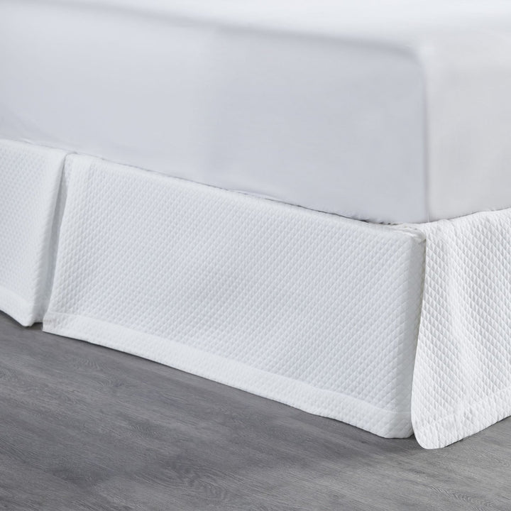 BS-117-7880_2|Close-up of white quilted panel bed skirt, highlighting the intricate diamond pattern and luxurious texture for bedrooms.