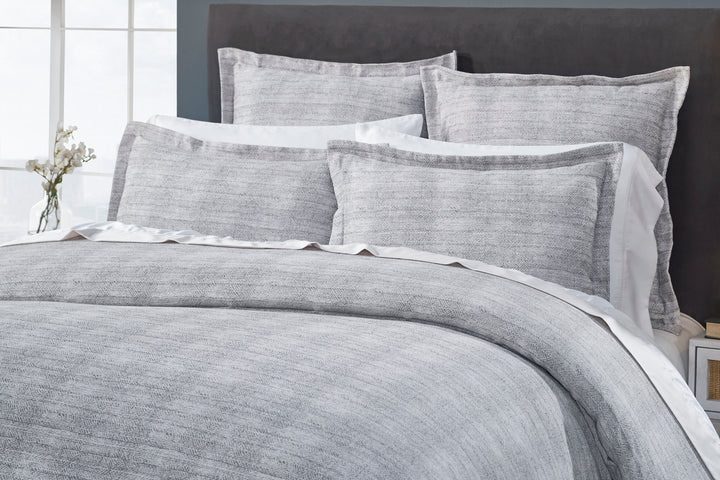 DT-035-9092_3|Close-up of a luxurious gray textured duvet cover and coordinating shams, highlighting the intricate woven pattern.