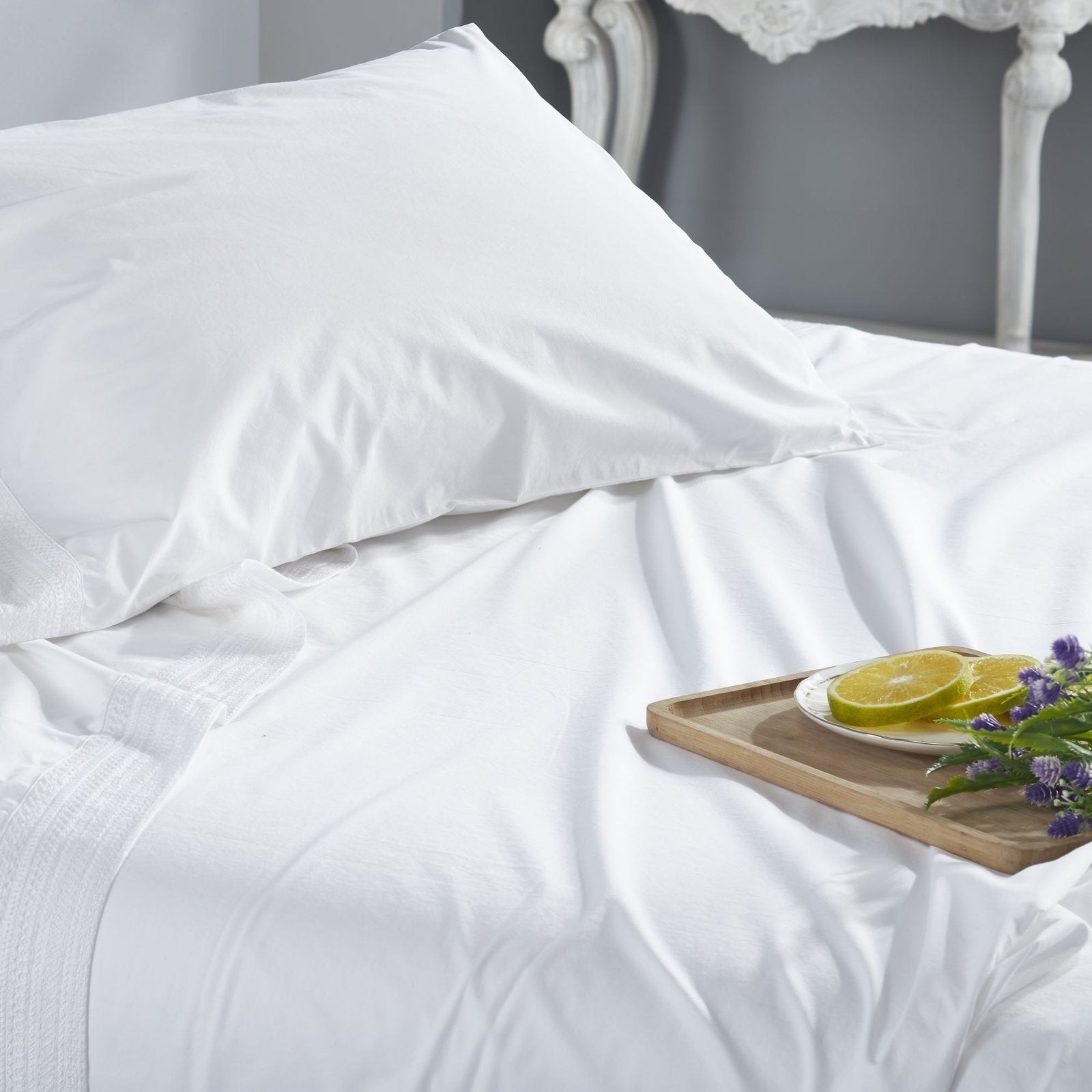 CSS-520-7284_3|Close-up of soft white 100% cotton sheets and pillow, detailed with elegant stitching for a luxurious feel.