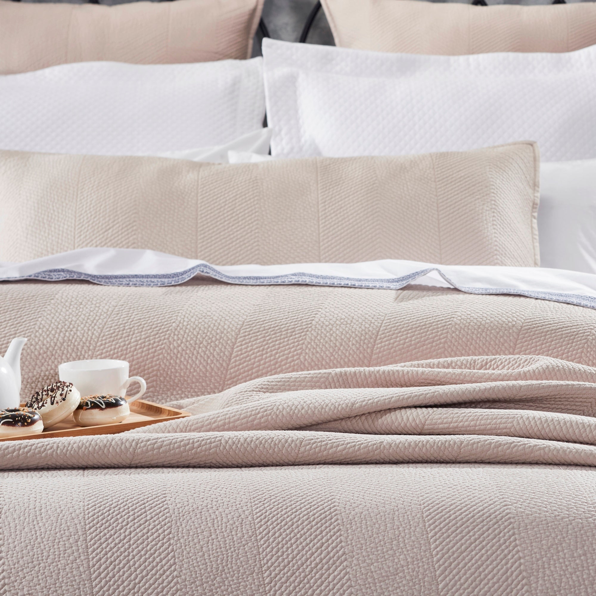 CL-171-11096_4|Cozy neutral beige chevron coverlet on a bed. Luxurious textured bedding, perfect for a comfortable and inviting bedroom.