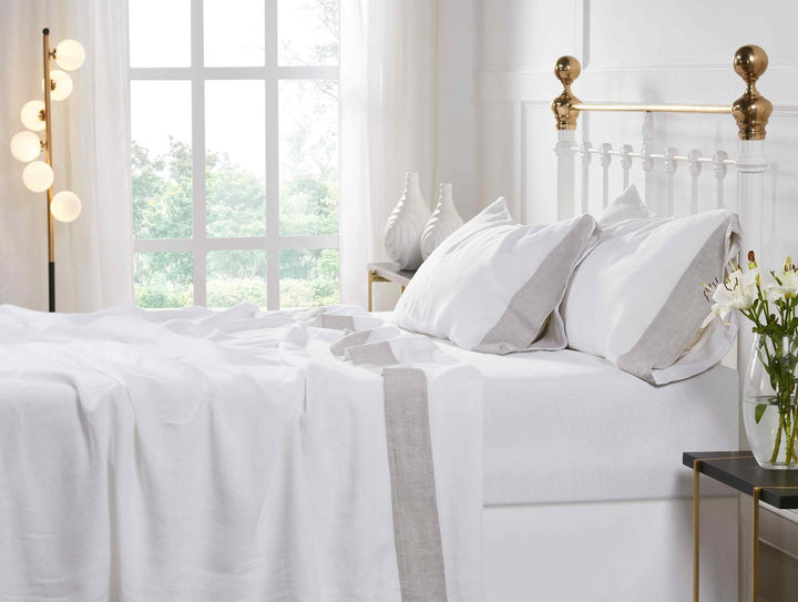CSS-518-7284_5|Inviting bedroom featuring a bed dressed with white 100% linen sheets and pillowcases with stylish grey borders.