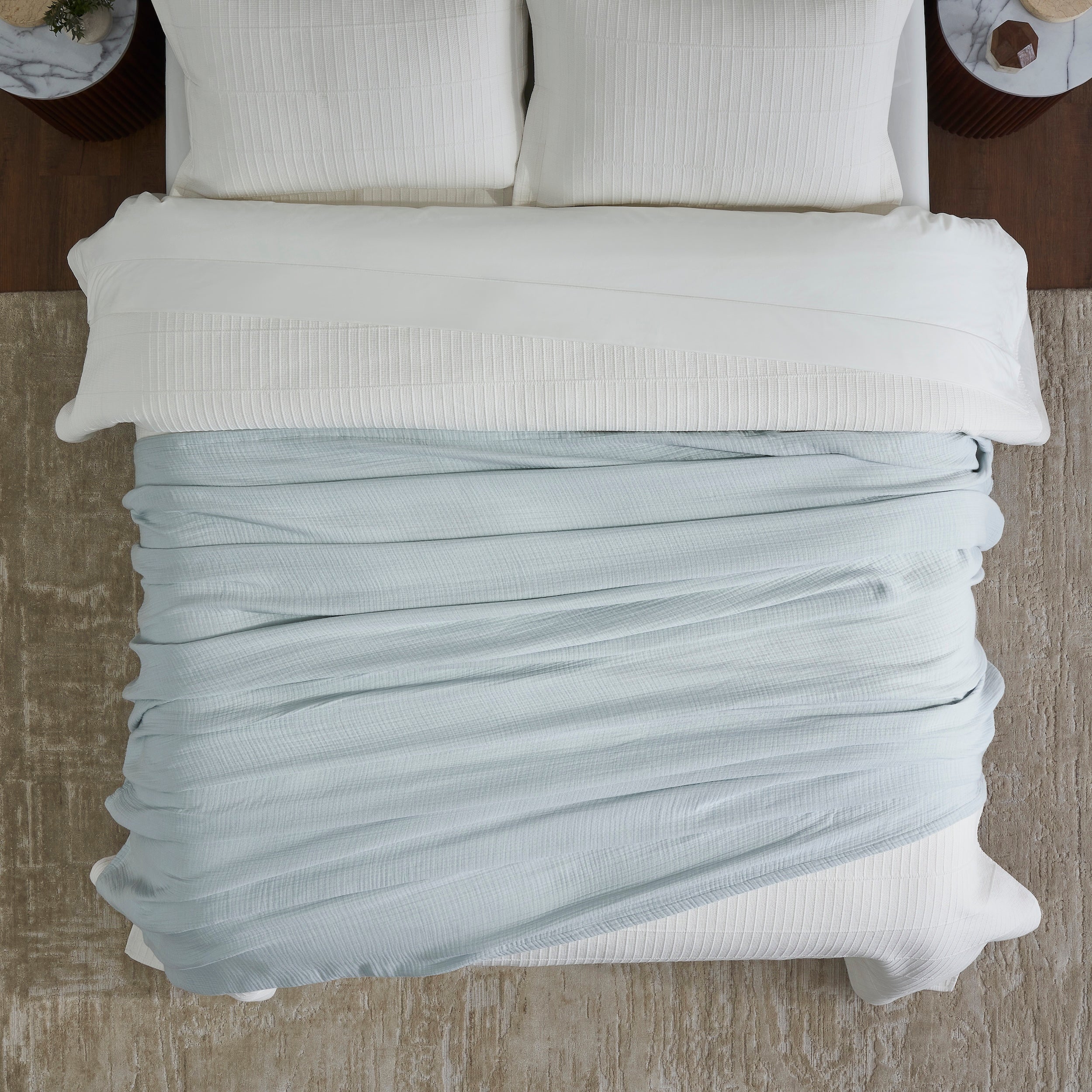 BL-863-9496_4|Overhead view of soft light blue muslin gauze blanket, a cozy, breathable layer for comfortable sleep and bedroom style.