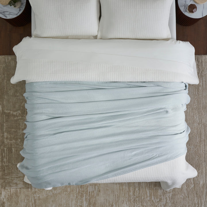 BL-863-9496_4|Overhead view of soft light blue muslin gauze blanket, a cozy, breathable layer for comfortable sleep and bedroom style.