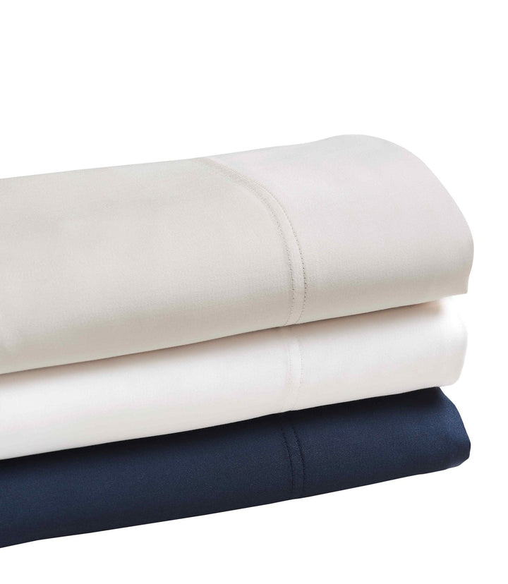 QSS-510-6080_2|Stacked pristine 100% Lyocell sheets in white, beige, and navy, highlighting their smooth, cooling drape.
