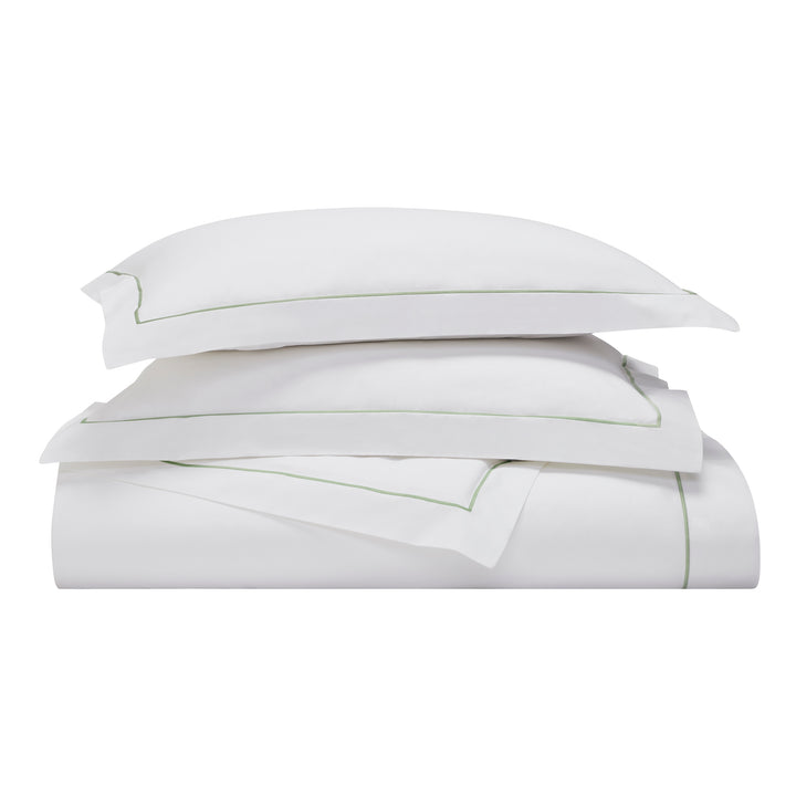 KS-057-2036_3|Stacked white duvet cover and two matching pillow shams with thin olive green embroidered borders. Luxurious, soft, elegant hotel quality set.
