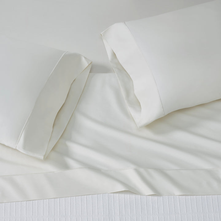 ASP-546-X_2|White 100% cotton sateen sheet set on a bed, featuring a flat sheet and two hemmed pillowcases, smooth finish.
