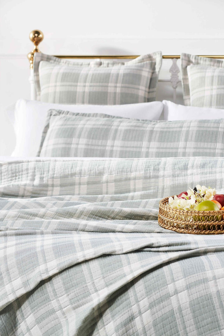 BT-119-11096_1|Sage green and white plaid quilted blanket draped on a bed with matching pillows, perfect for cozy bedroom decor.