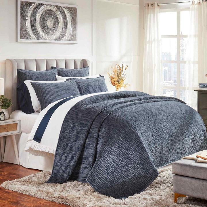 CL-195-9496_2|Luxurious navy blue quilted coverlet draping a bed with matching pillows, adding elegance and comfort to the master bedroom.