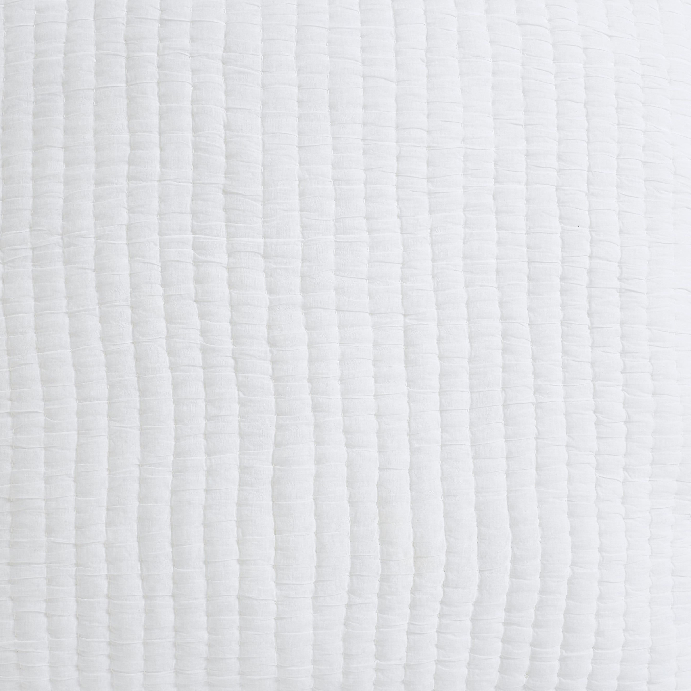 QT-359-9496-LOT1_9|Detailed close-up of a white textured quilt with linear stitching, showcasing soft, breathable cotton fabric for comfort.
