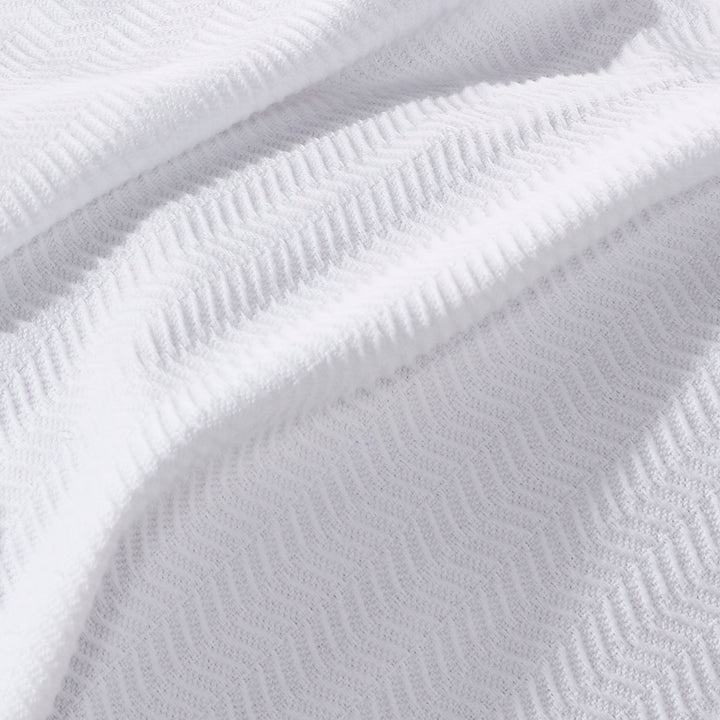 BL-853-9496_4|Close-up of the white herringbone pattern blanket, detailing its intricate chevron texture and soft feel.