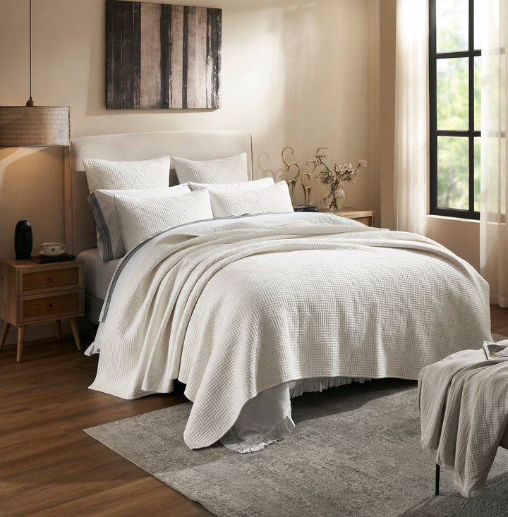 CL-199-9496_2|Inviting white quilted coverlet with a stylish herringbone pattern draped over a bed, enhancing a modern bedroom.