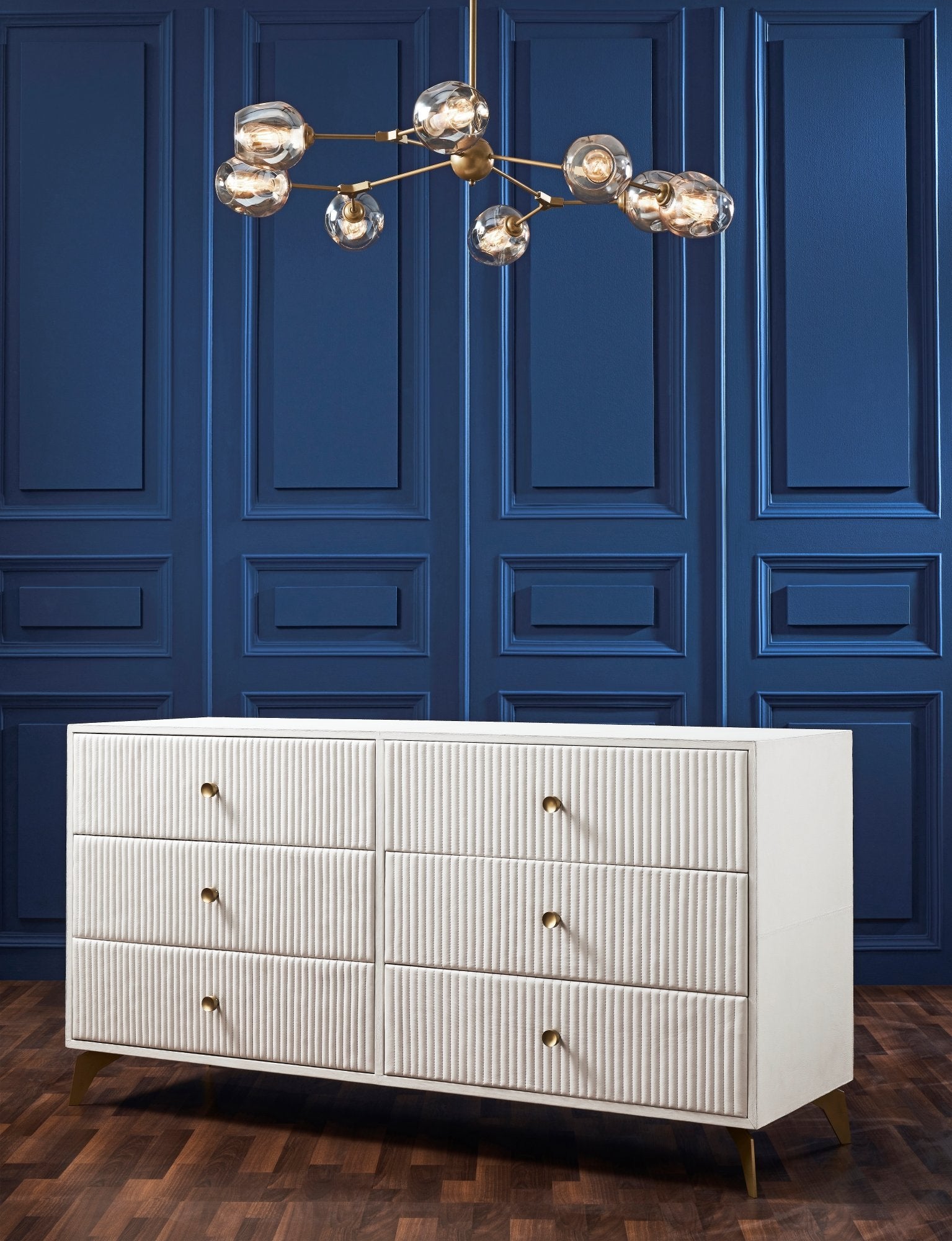 FN-5203-642033_6|Full view of a stunning white six-drawer ribbed dresser with elegant gold legs, enhancing a sophisticated living space.