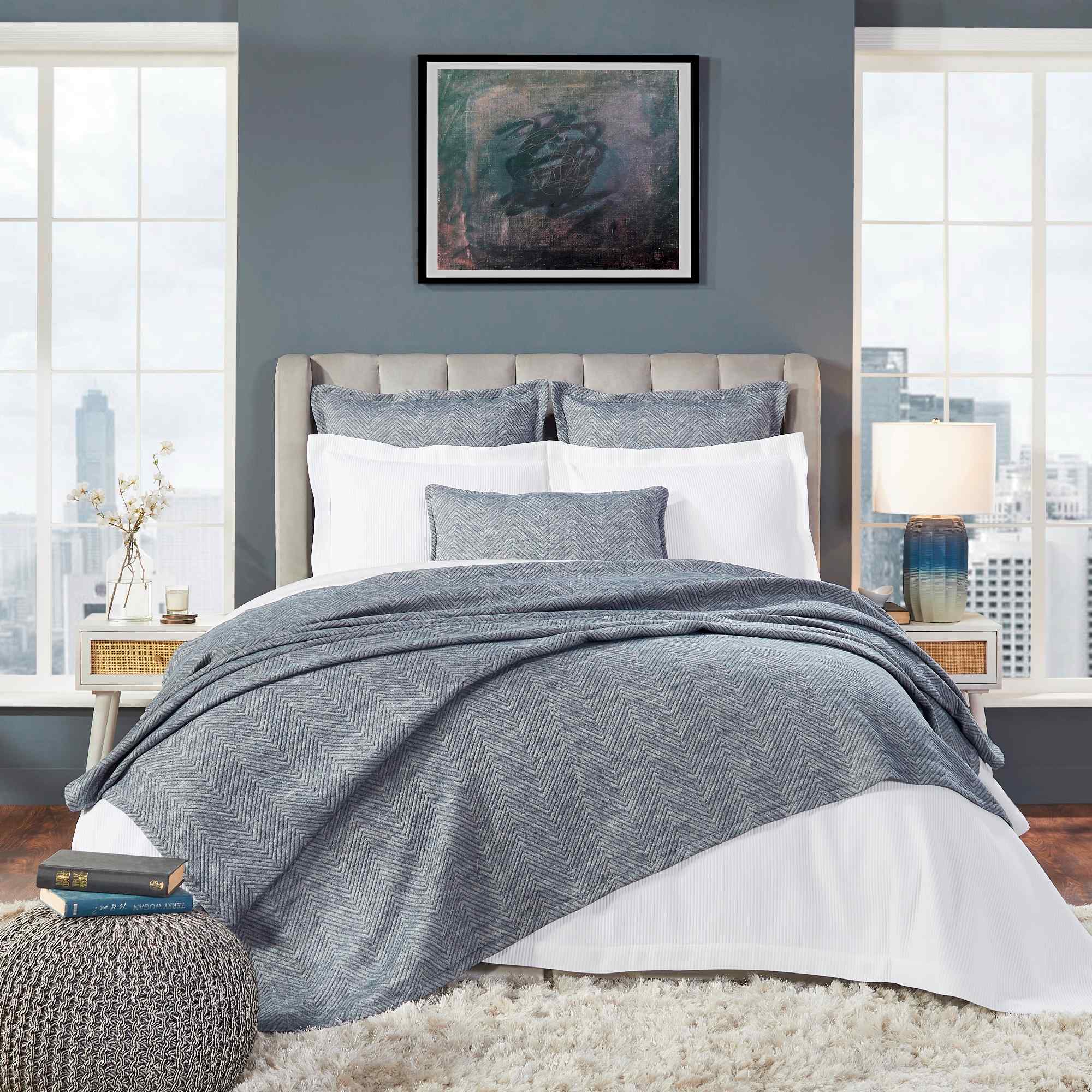 BT-123-9496_1|Modern bedroom with a gray chevron throw blanket draped over a white bed, adding texture and warmth.