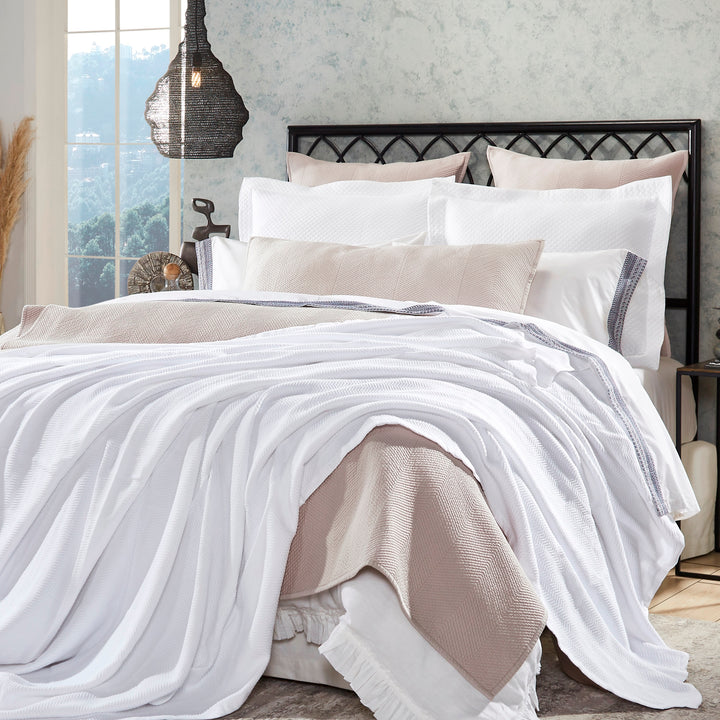 BL-853-9496_1|Draped white waffle weave blanket on a cozy bed with neutral bedding, adding a luxurious texture to bedroom decor.