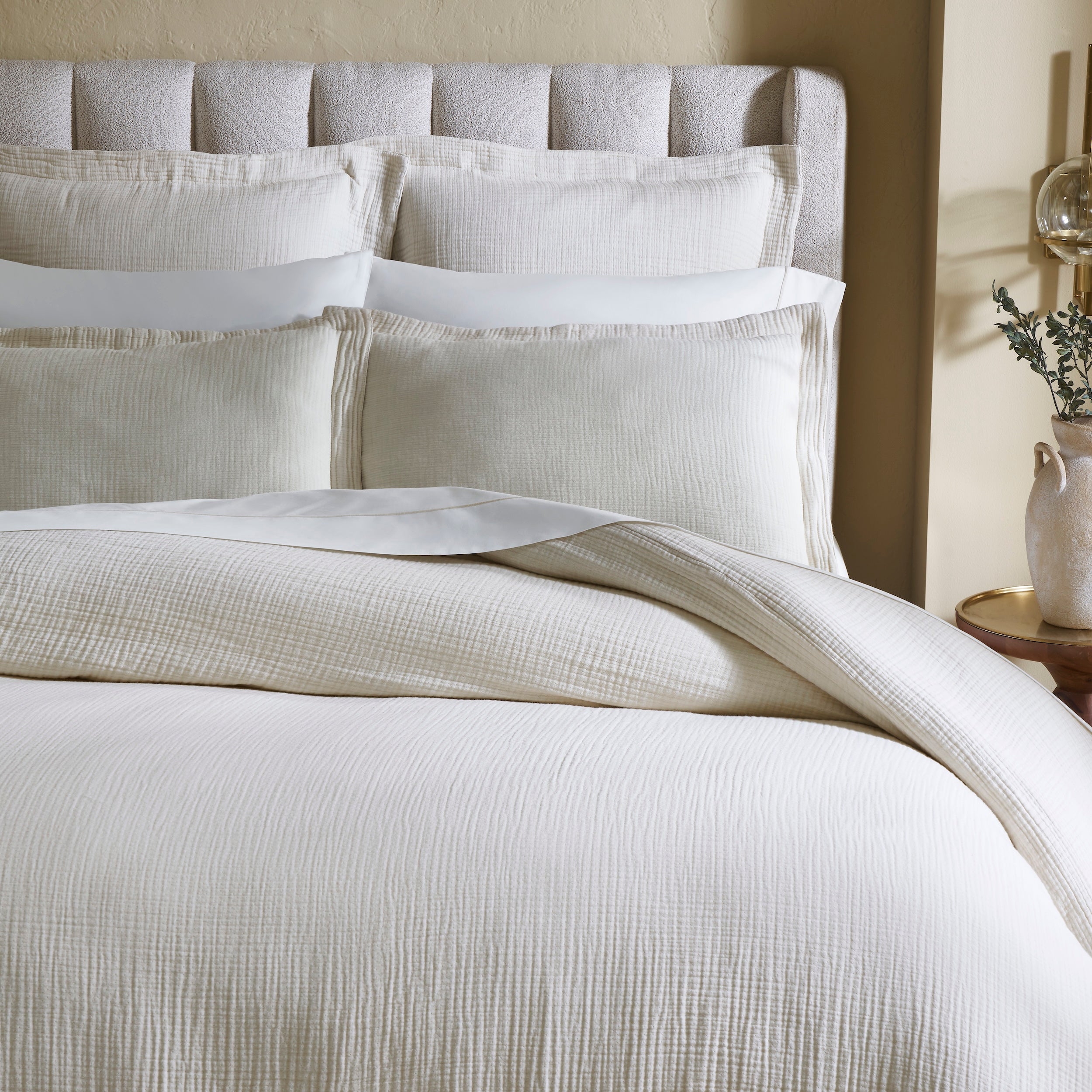 DT-049-10692_3|Close-up of soft cream textured duvet cover and matching pillows, showcasing luxurious, elegant bedding details.