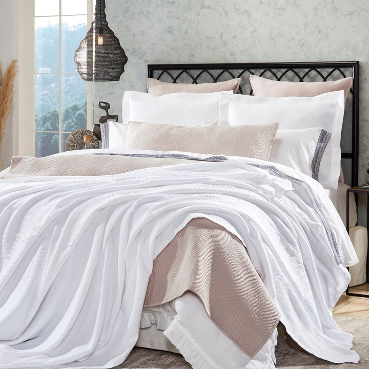 BL-853-11096_1|Cozy white textured blanket draped over a stylish bed, enhancing bedroom comfort with its inviting, breathable design.