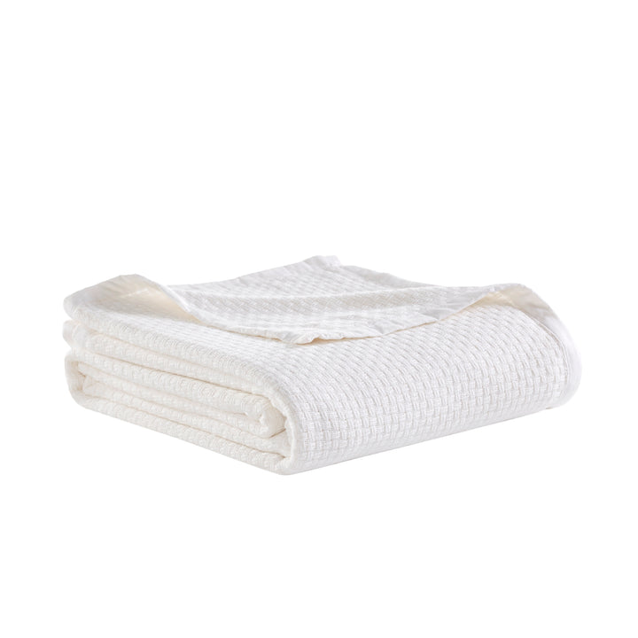 BL-852-11096_3|Neatly folded white waffle weave blanket, crisp and textured, providing comfort and a clean look for any room.