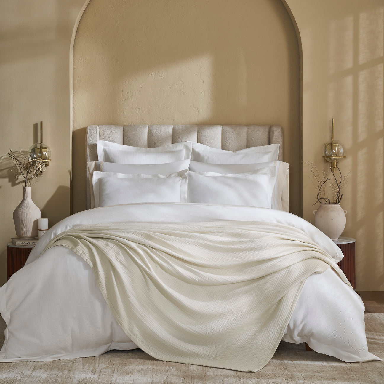 BL-861-X_1|Cream textured cotton blanket draped elegantly over a pristine white bed, adding a touch of warmth and sophisticated comfort to the bedroom.