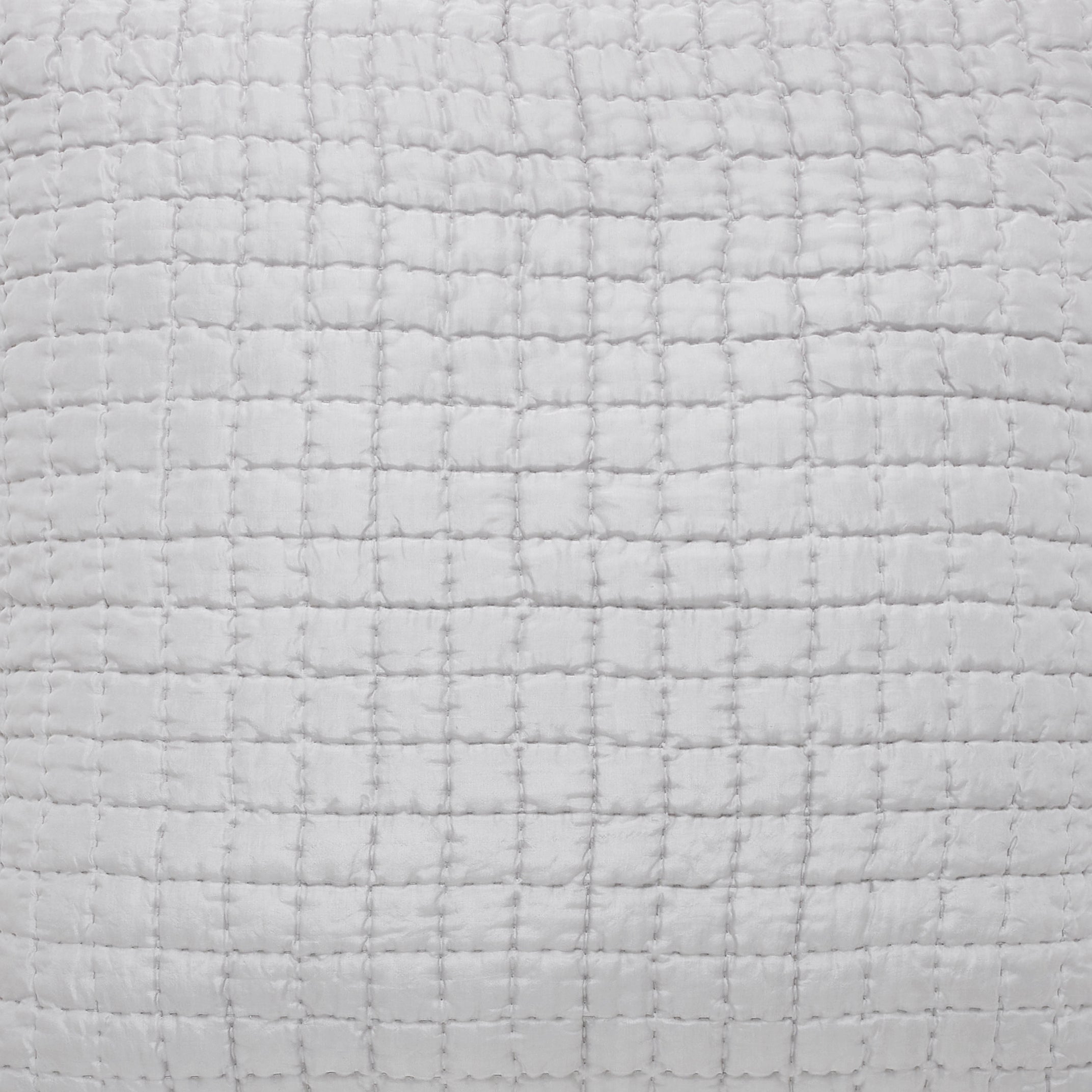 CL-177-9496-LOT1_2|Close-up of a crisp white quilted coverlet with a grid texture, highlighting the soft and comfortable bedding material.