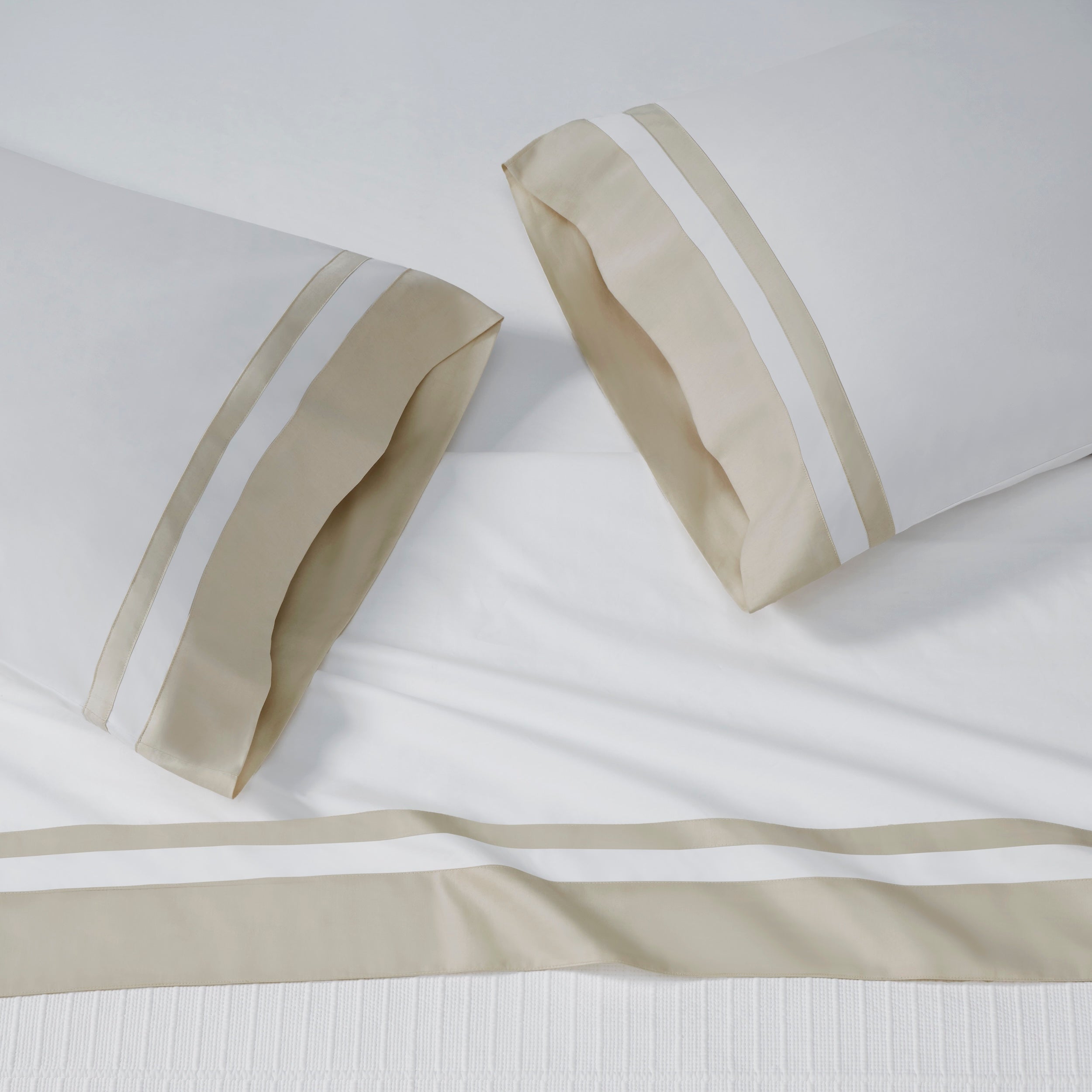 ASP-543-2032_2|White 100% cotton sateen flat sheet and two pillowcases, each featuring a wide beige border with dual white stripes.