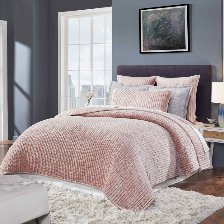 QT-354-9496_4|Full view of a luxurious dusty pink velvet channel-quilted quilt and shams on a stylish bed. Cozy bedroom.