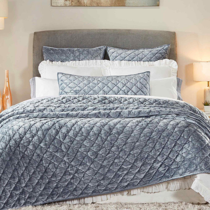QT-341-11096_4|Luxurious blue velvet quilted quilt and shams, diamond pattern, draped elegantly over a bed. Chic bedroom decor.