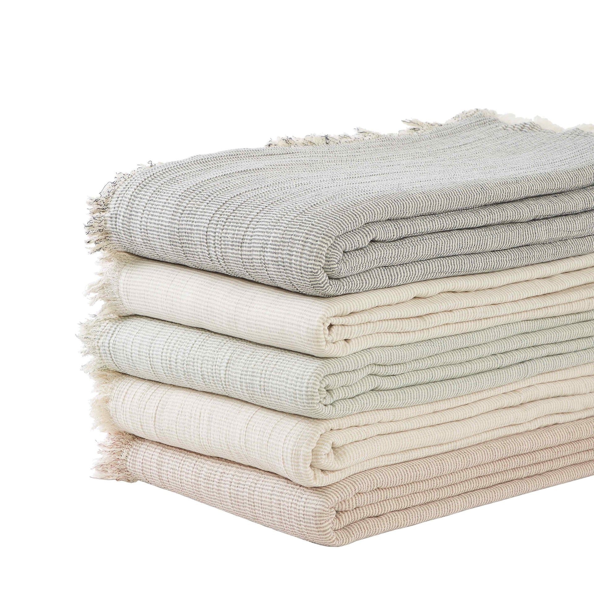 BT-111-X_2|Stack of assorted neutral striped cotton blankets with elegant fringe edges, offering comfort and style for home decor.