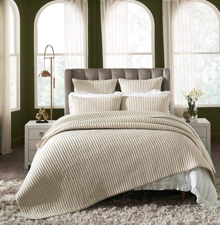 QT-368-11096_1|Elegant bedroom with beige ribbed quilted quilt, shams, and throw pillows, creating a cozy and inviting atmosphere.
