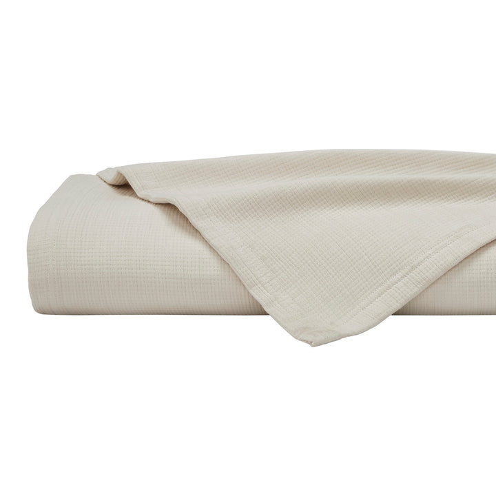 BL-860-9496_6|Neatly folded light beige waffle weave blanket, soft and textured, perfect for a cozy bedroom or living space decor.