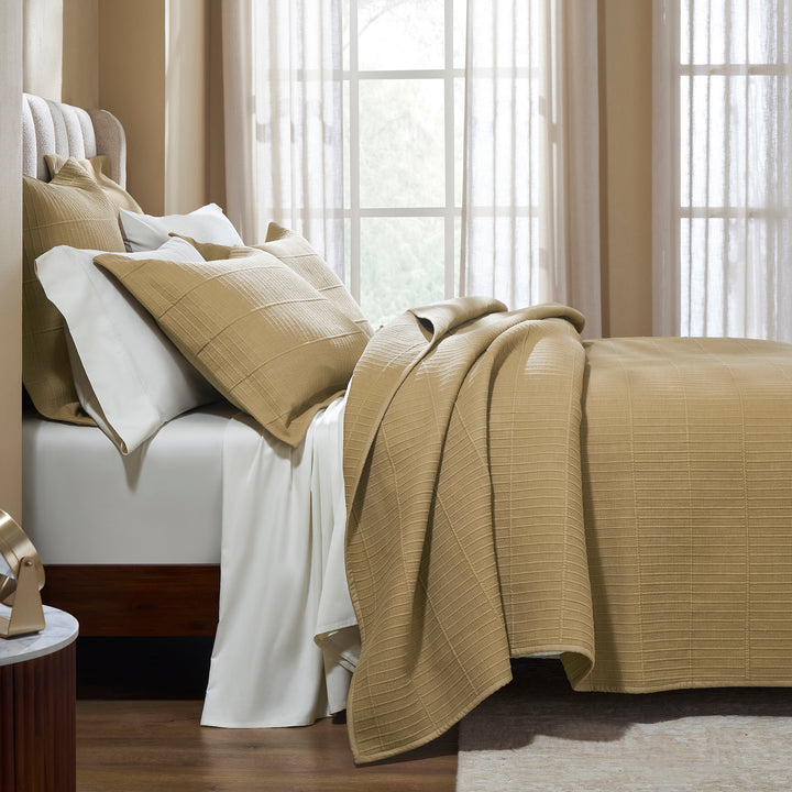 CL-269-9496_3|Cozy beige textured coverlet neatly folded on a bed, showcasing its soft texture and inviting neutral bedroom appeal.