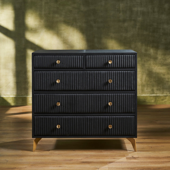 FN-5217-482036_1|Elegant black ribbed leather dresser with gold drawer pulls and tapered legs, offering luxurious modern bedroom storage.