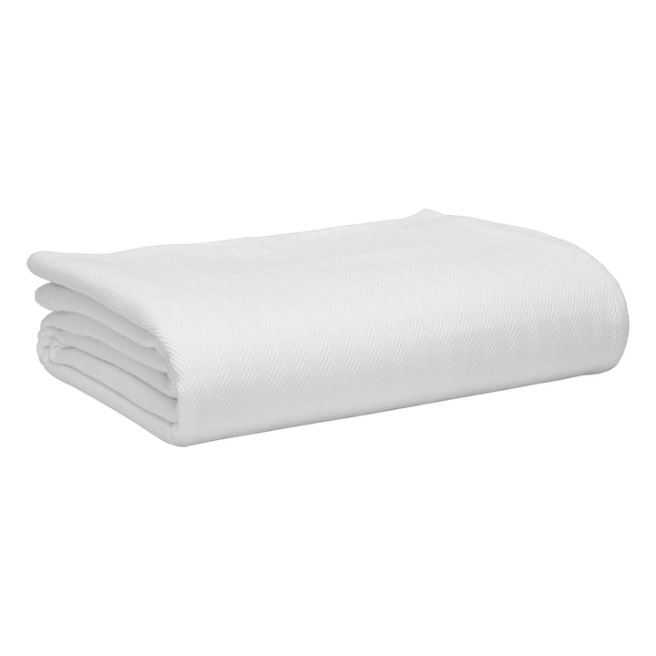 BL-865-9496_7|Neatly folded white herringbone textured blanket, perfect for adding warmth and style to any bedroom or living space.