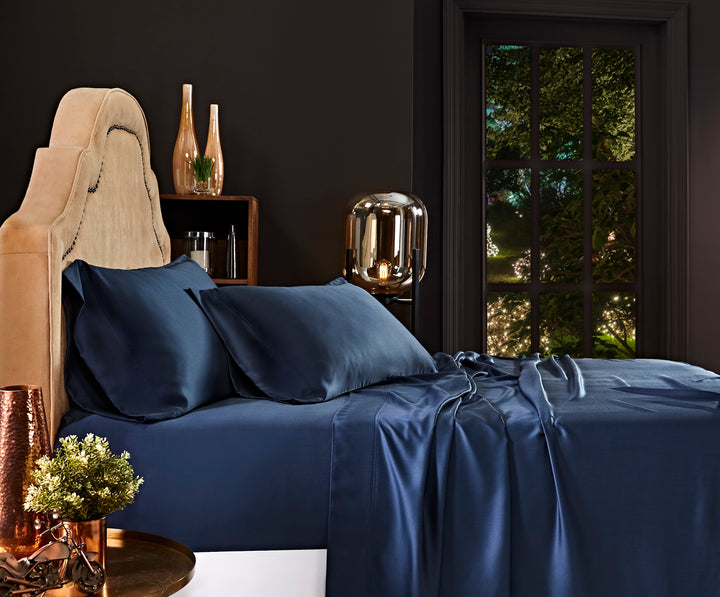 CSS-511-7284_2|Navy 100% Lyocell sheet set on a bed. Includes two pillowcases and a flat sheet with a smooth sateen weave.
