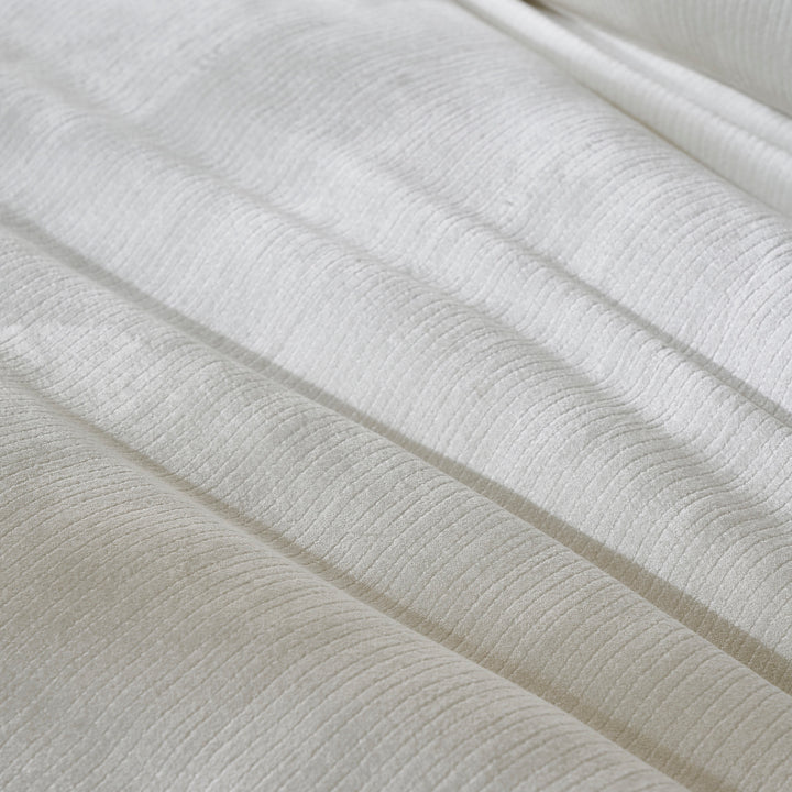 DT-052-9092_6|Extreme close-up of a luxurious white textured duvet cover, showcasing its subtle ribbed fabric and elegant soft folds.