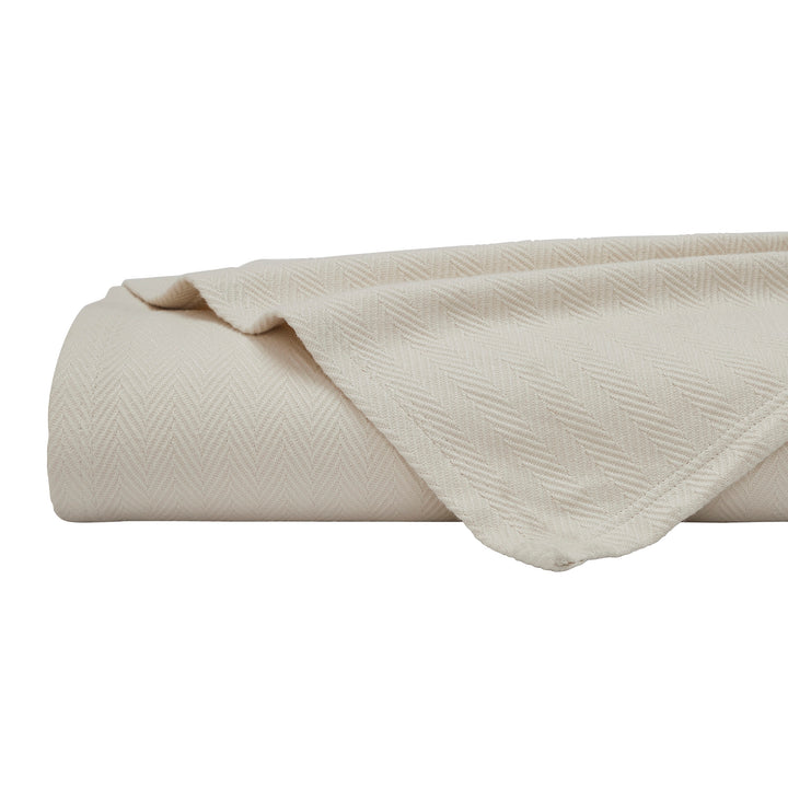 BL-866-9496_6|Rolled and folded soft light beige herringbone woven blanket on white background, highlighting its inviting texture.