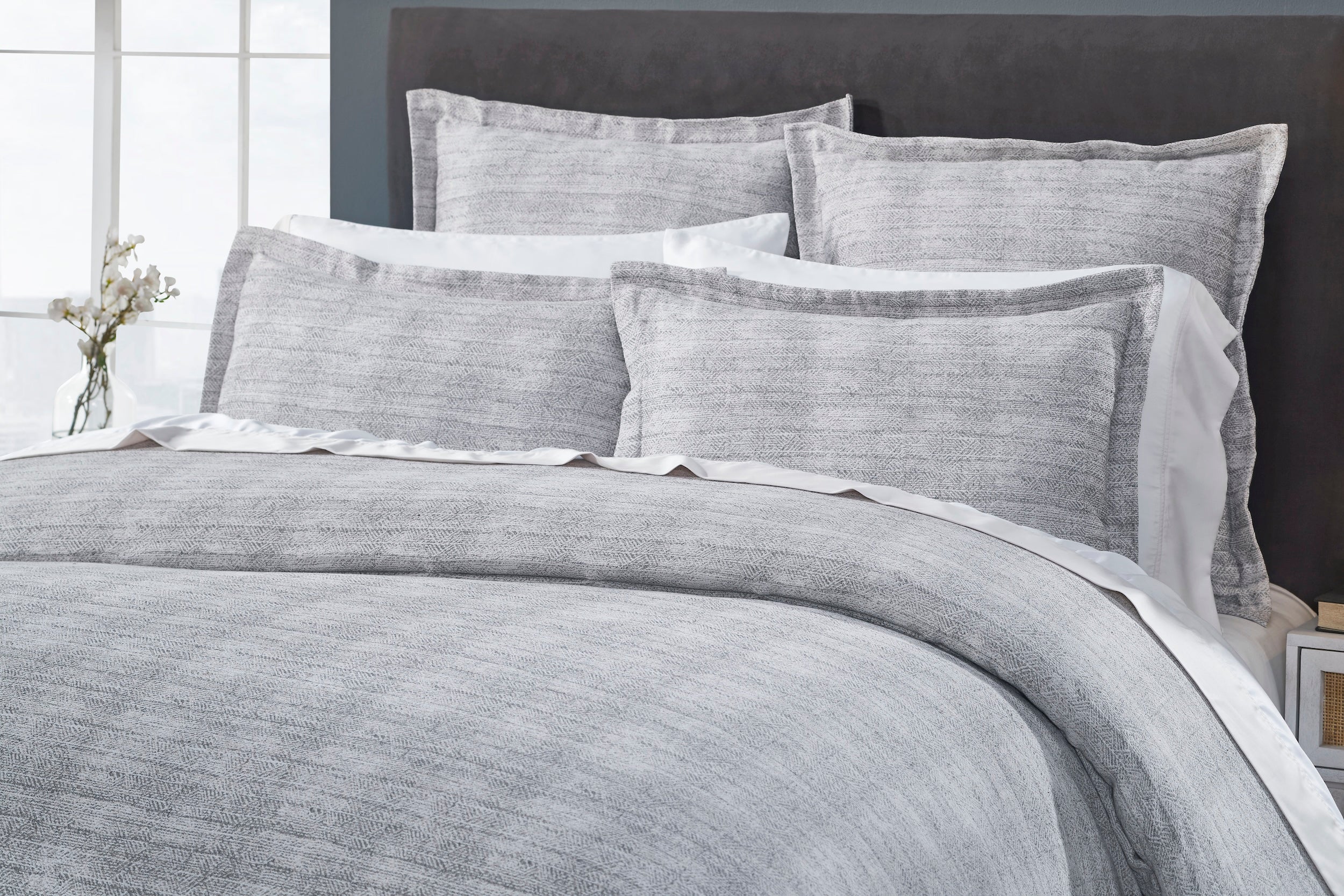 DT-035-10692_3|Close-up of a luxurious gray textured duvet cover and coordinating shams, highlighting the intricate woven pattern.