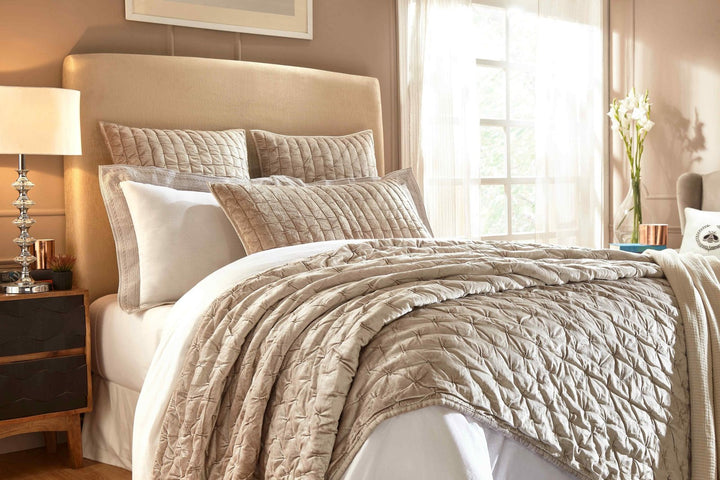 QT-312-11096_2|Soft beige velvet quilt featuring a beautiful geometric pin-tuck pattern, draped artfully on a bed, enhancing bedroom style.