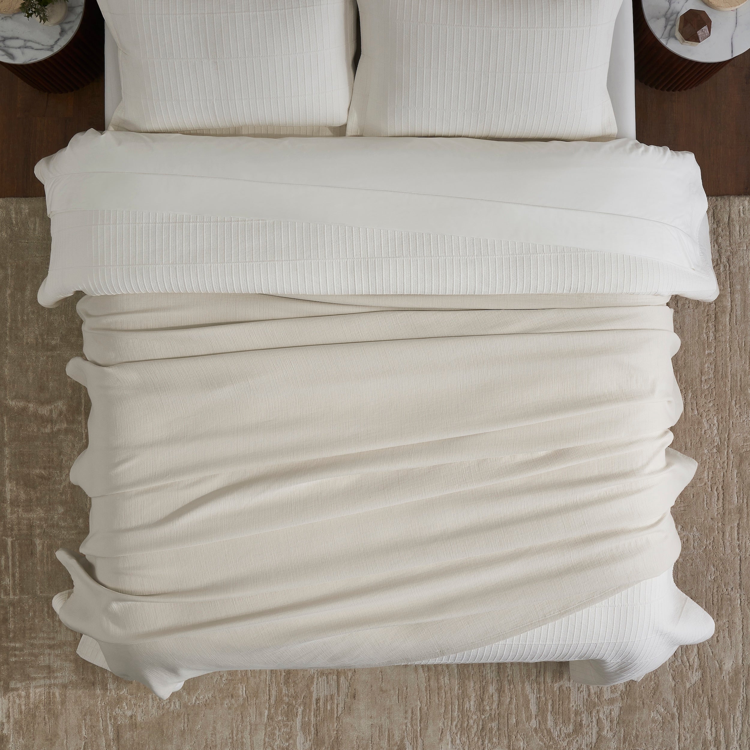 BL-860-9496_4|Cozy light beige textured waffle weave blanket on a modern bed with white sheets, perfect for layering and comfort.