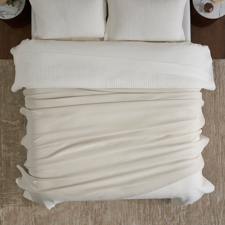 BL-860-9496_4|Cozy light beige textured waffle weave blanket on a modern bed with white sheets, perfect for layering and comfort.