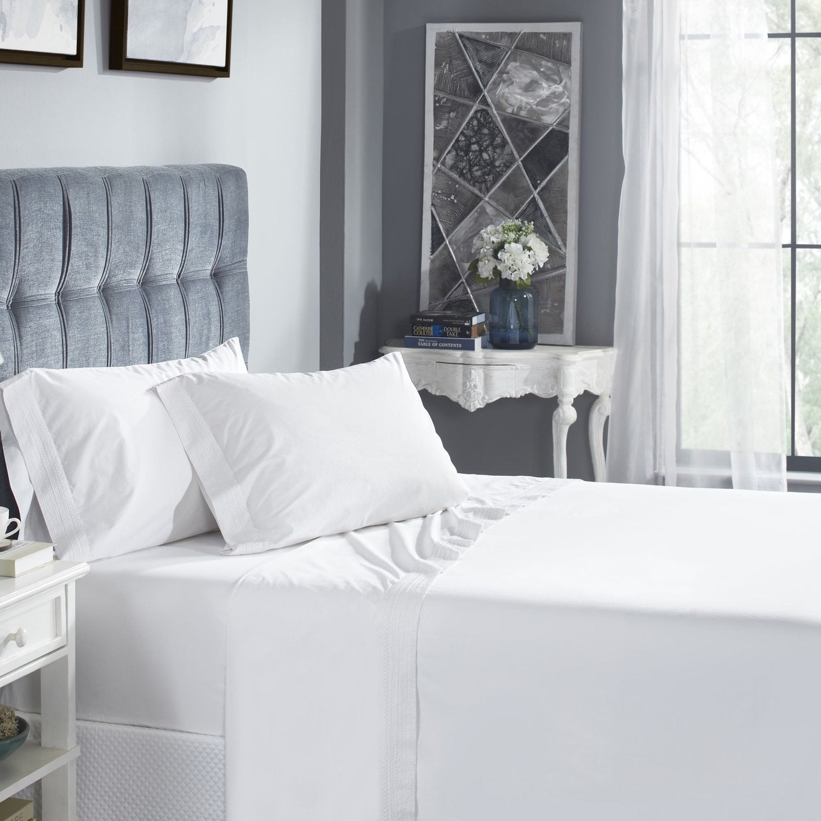 CSS-520-7284_1|Serene bedroom showcasing a comfortable bed with crisp white 100% cotton sheets and decorative stitching.