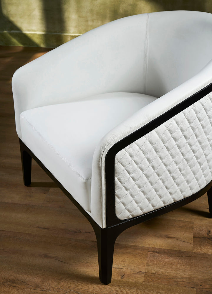 FN-5204-343329_6|Close-up angle of white leather armchair with quilted side and dark wood frame, highlighting luxury leather furniture details.
