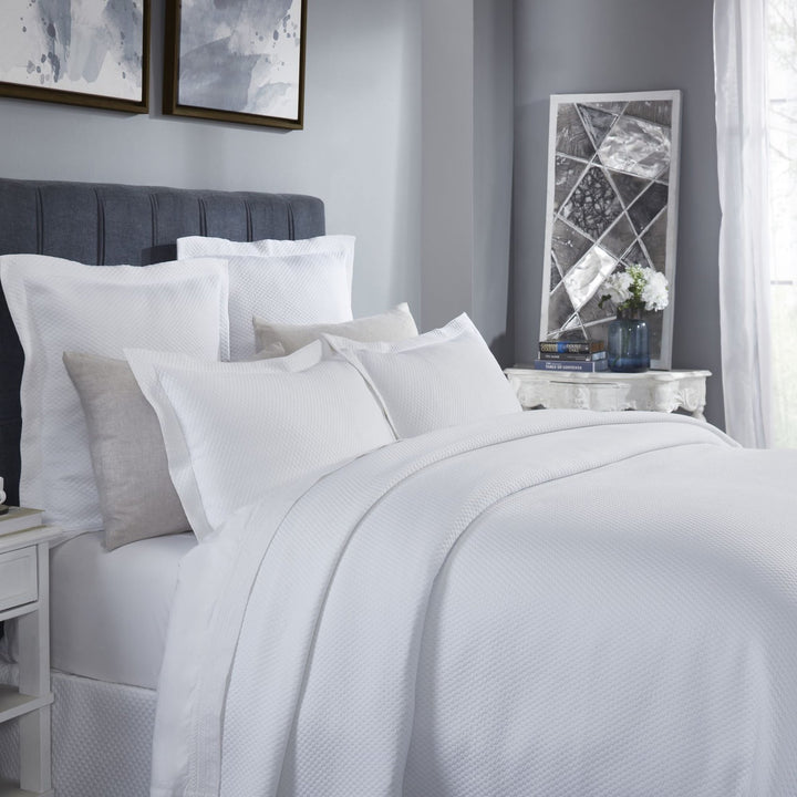 CL-256-9496_2|Chic white honeycomb textured coverlet on a contemporary bed, creating a serene and inviting sleep sanctuary.