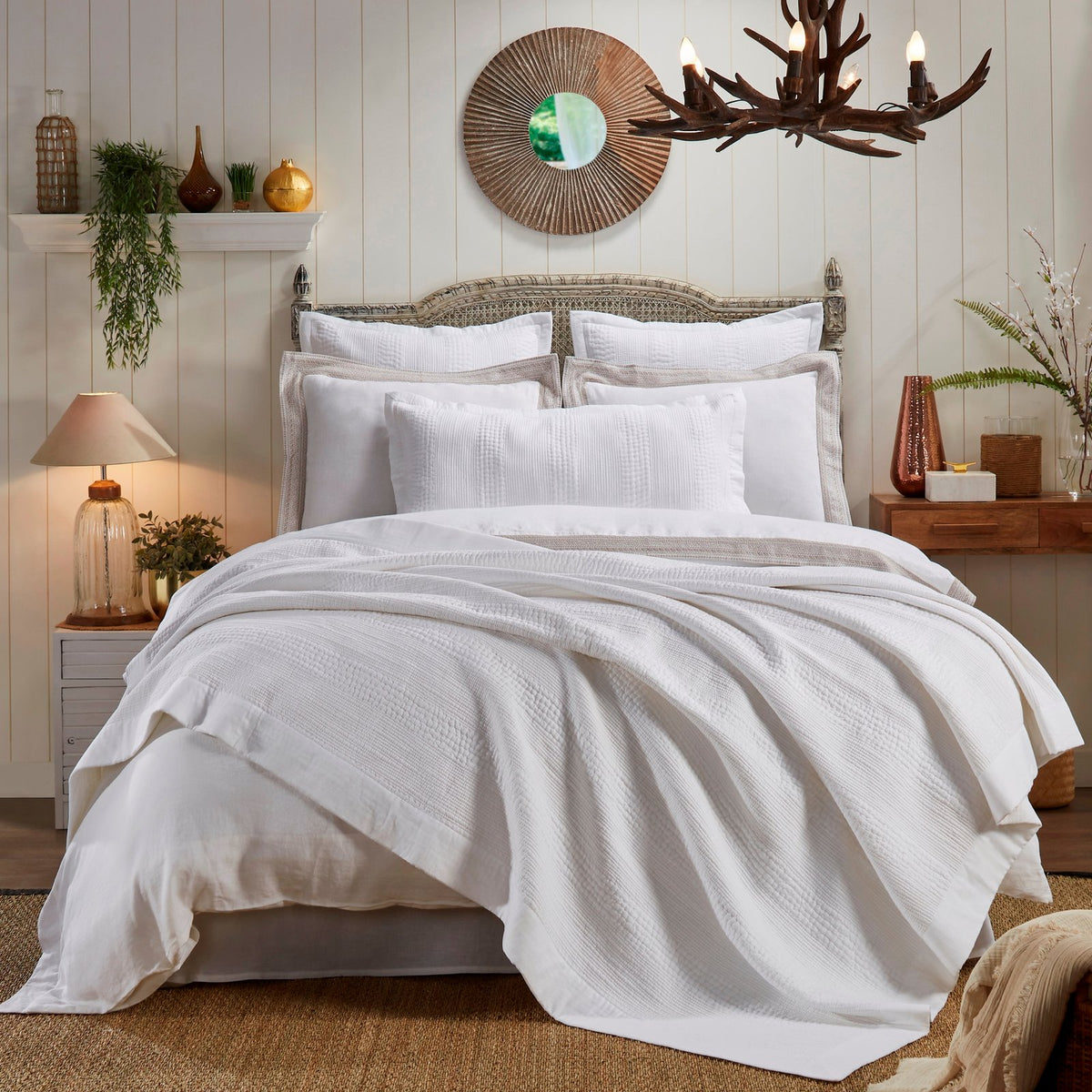 CL-163-9496_1|White textured coverlet beautifully draped over a bed in a bright, modern rustic bedroom, enhancing serene decor.