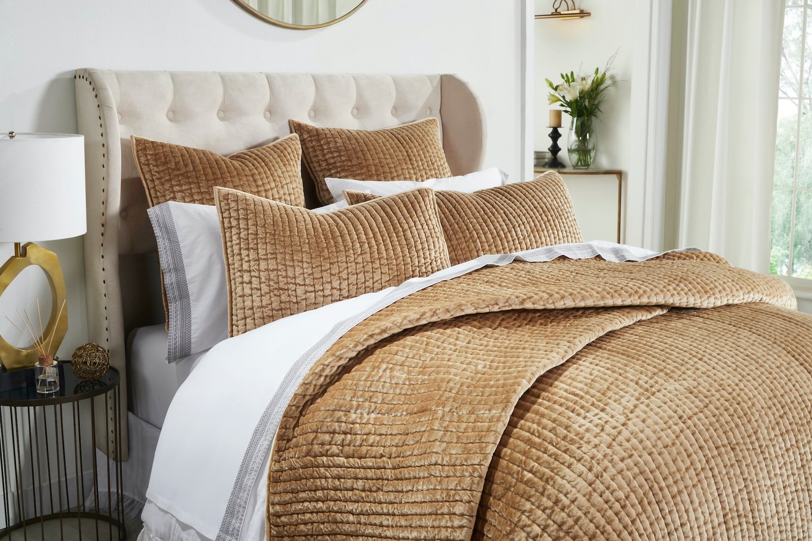 QT-362-11096_3|Close-up of a luxurious golden-brown velvet channel-quilted bed quilt and pillows, highlighting soft texture.