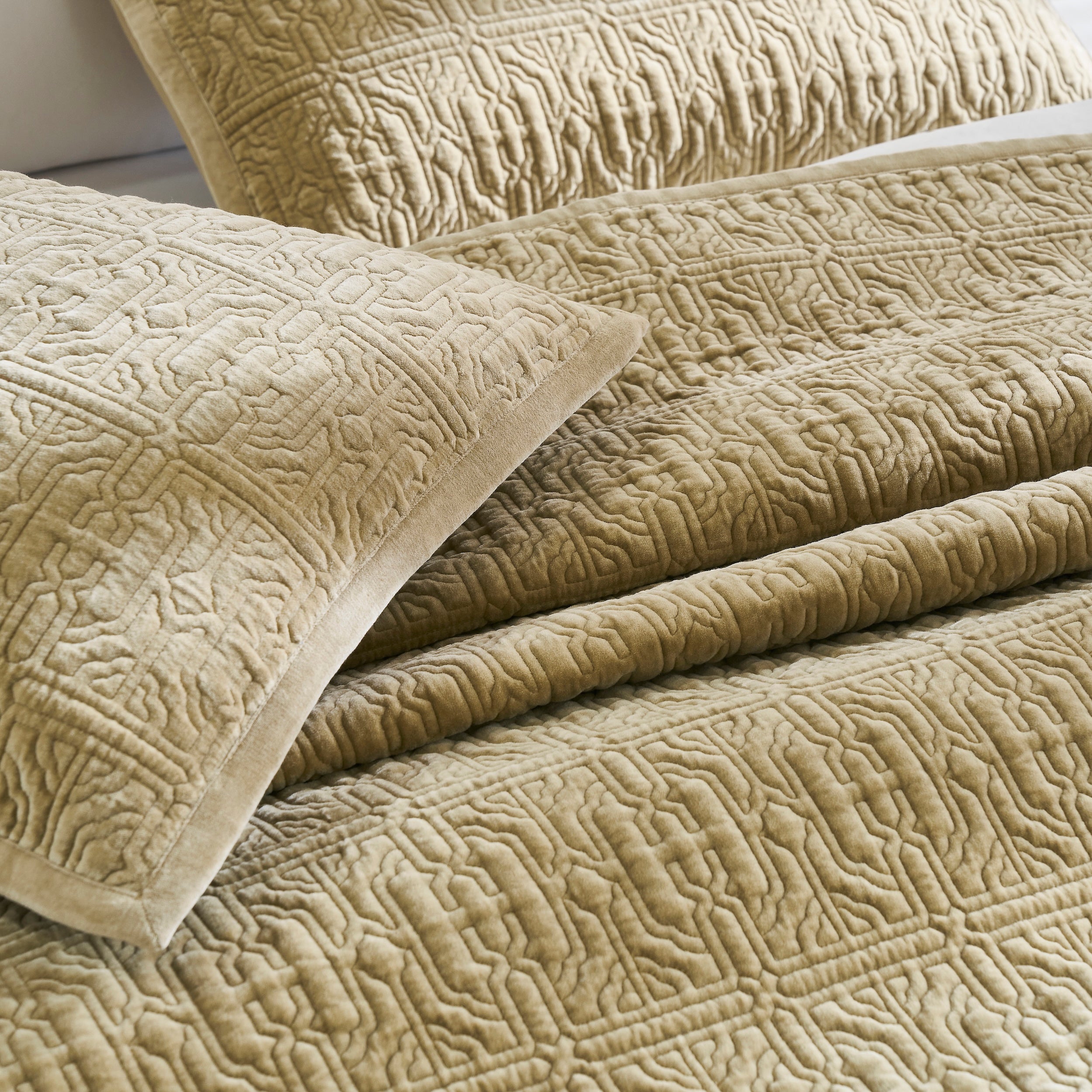 ES-377-2626_3|Luxurious tan quilted velvet bedding set with pillows, featuring intricate geometric patterns for an elegant bedroom.