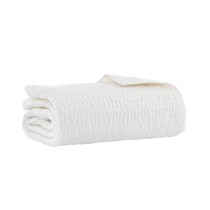 QT-359-9496-LOT1_6|Neatly folded pure white quilted cotton blanket, highlighting its soft texture and elegant stitched design. Perfect for warmth.