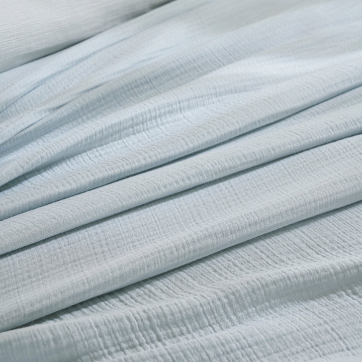 BL-863-11096_5|Detailed close-up of luxurious light blue textured muslin blanket fabric, highlighting its soft ripples and folds.